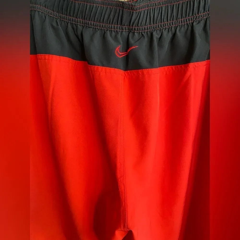 Red and black Nike swim trunks‎